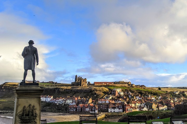 a person standing in front of a statue