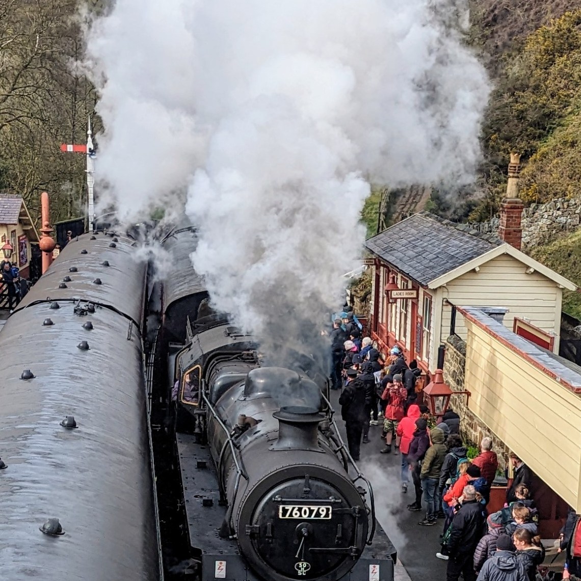 a steam train on a track with smoke coming out of it