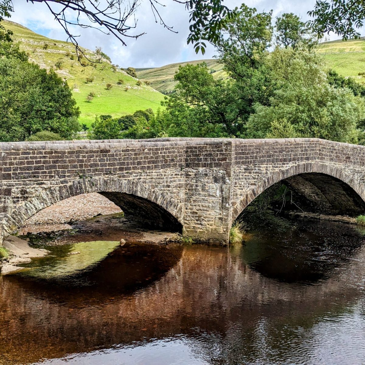 a stone bridge over a body of water
