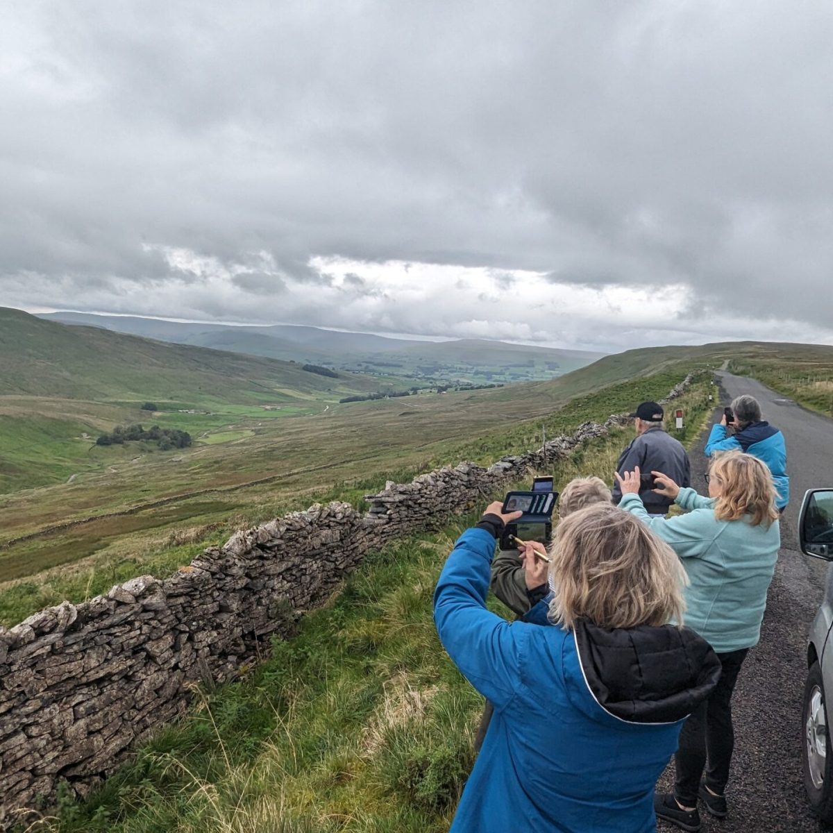 a man and a woman standing next to a car