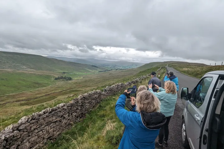 a man and a woman standing next to a car